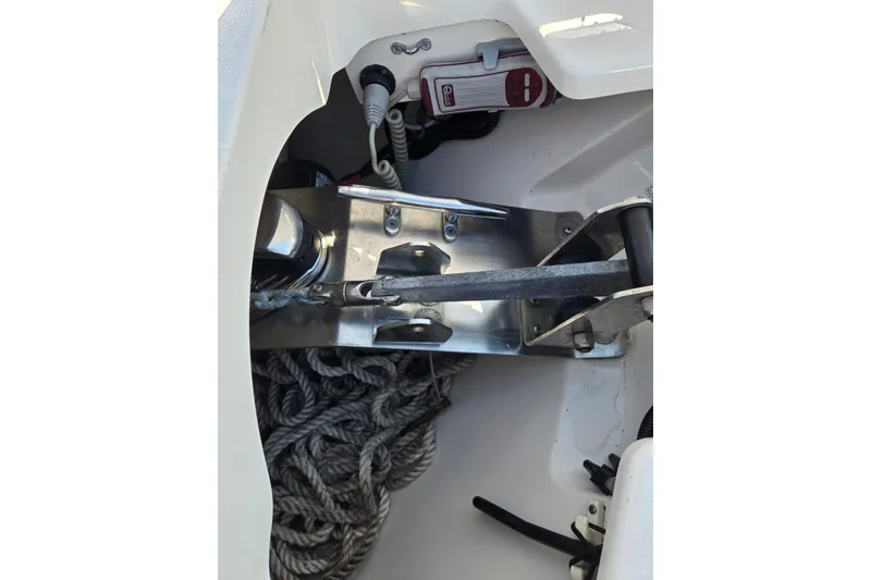 Slide: The Image of 2014 Boston Whaler 270 Vantage anchor compartment with rope and metal fittings. - 20