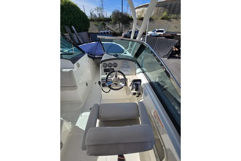 Slide: The Image of 2014 Boston Whaler 270 Vantage boat cockpit with steering wheel and controls. - 29