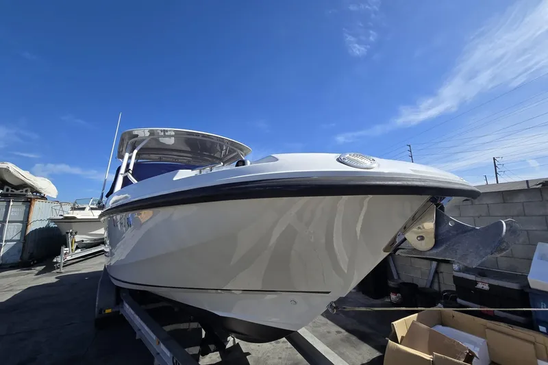 Slide: The Image of 2014 Boston Whaler 270 Vantage boat on trailer under clear blue sky. - 32