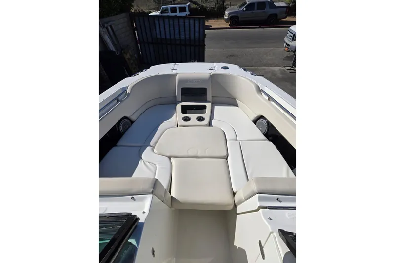 Slide: The Image of 2014 Boston Whaler 270 Vantage boat interior with white cushioned seating. - 35