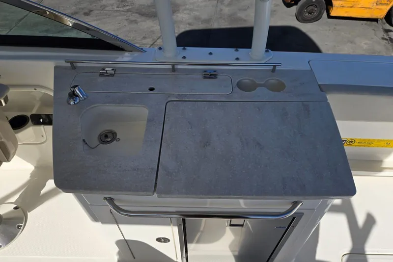 Slide: The Image of 2014 Boston Whaler 270 Vantage boat sink and countertop area. - 41