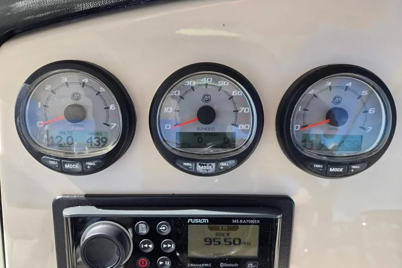 Slide: The Image of Dashboard of a 2014 Boston Whaler 270 Vantage with gauges and radio display. - 44