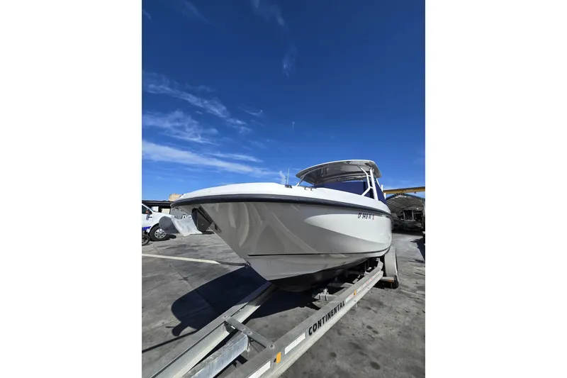 Slide: The Image of 2014 Boston Whaler 270 Vantage boat on trailer under clear blue sky. - 52