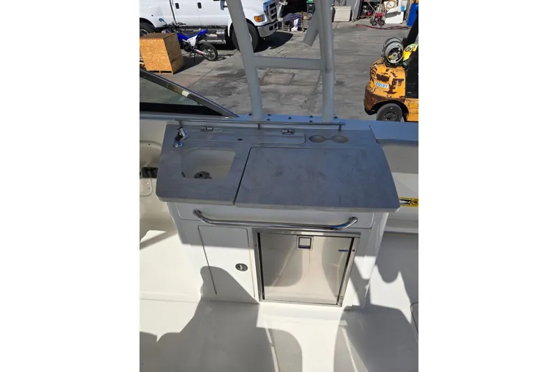 Slide: The Image of 2014 Boston Whaler 270 Vantage boat interior with sink and storage area. - 53