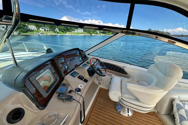 Slide: The Image of Luxurious 2006 Sea Ray 52 Sundancer yacht cockpit with navigation system and plush seating. - 10