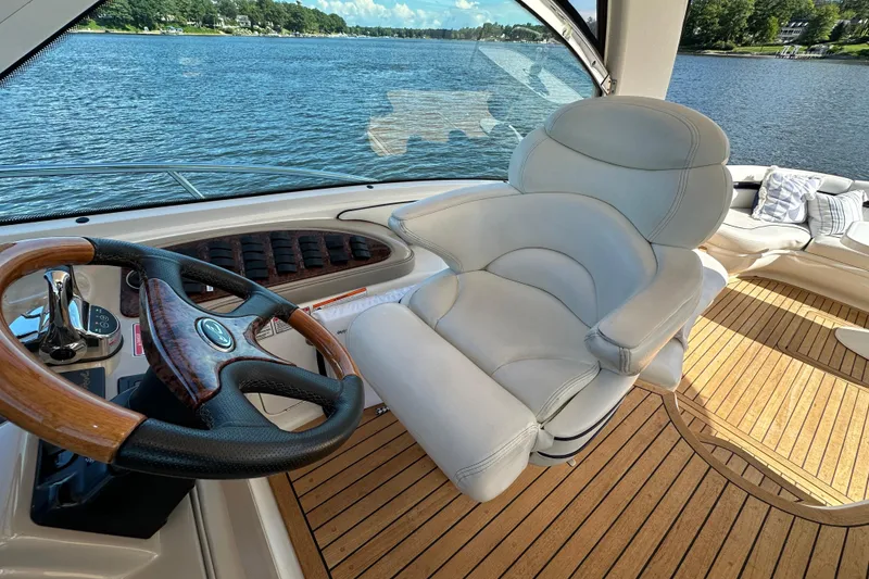 Slide: The Image of Luxurious helm of 2006 Sea Ray 52 Sundancer yacht with leather seat and wooden steering wheel. - 11