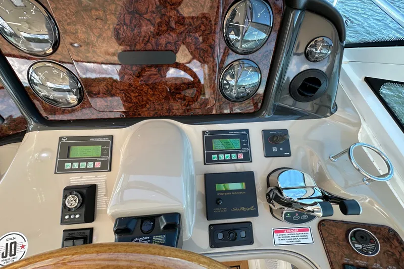 Slide: The Image of Control panel of a 2006 Sea Ray 52 Sundancer yacht with gauges and navigation controls. - 13