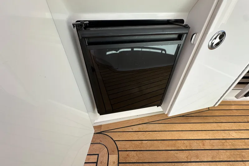 Slide: The Image of Mini fridge on 2006 Sea Ray 52 Sundancer yacht with teak flooring. - 15