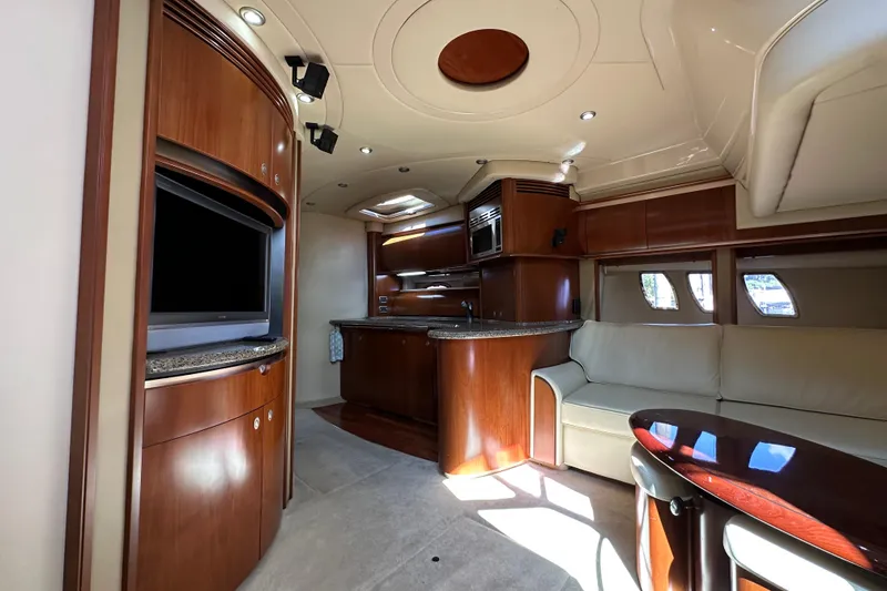 Slide: The Image of Luxurious interior of 2006 Sea Ray 52 Sundancer yacht with modern kitchen and seating area. - 17