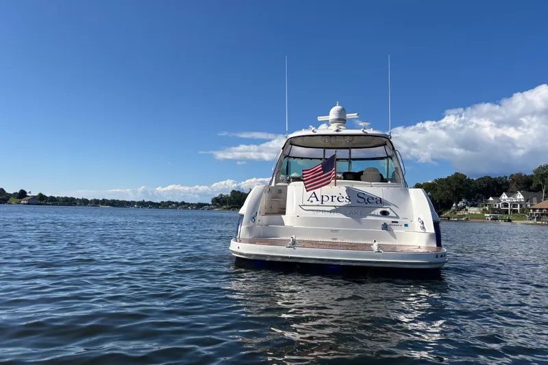 Slide: The Image of 2006 Sea Ray 52 Sundancer yacht on a sunny lake with American flag. - 2