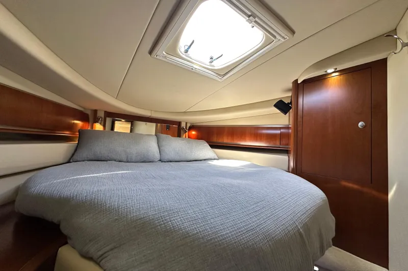 Slide: The Image of Luxurious cabin interior of 2006 Sea Ray 52 Sundancer yacht with skylight and wood accents. - 23