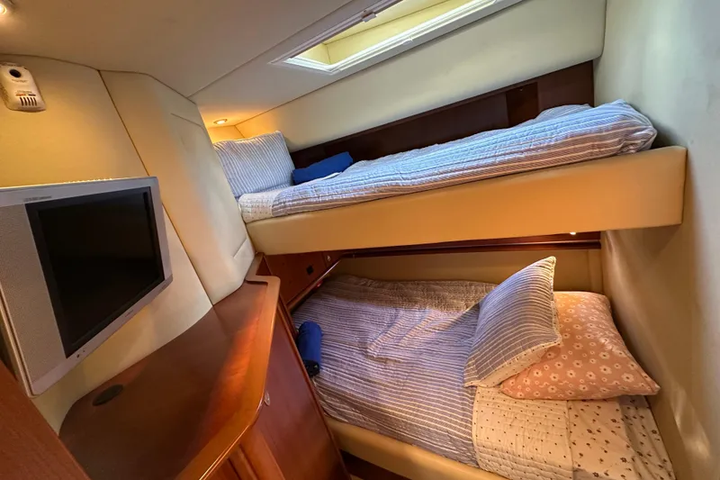 Slide: The Image of Interior of 2006 Sea Ray 52 Sundancer with bunk beds and wall-mounted TV. - 27