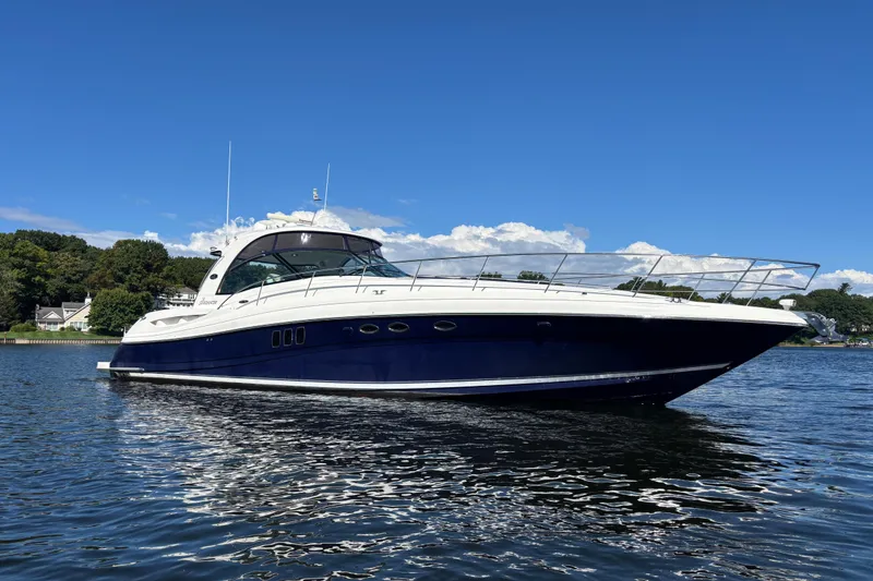 Slide: The Image of 2006 Sea Ray 52 Sundancer yacht on calm water under clear blue sky. - 30