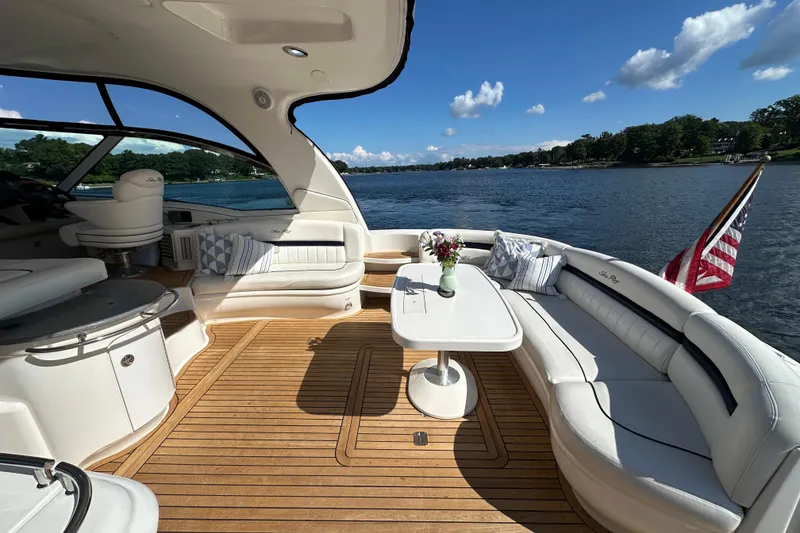 Slide: The Image of Luxurious 2006 Sea Ray 52 Sundancer yacht interior with elegant seating and scenic water view. - 4