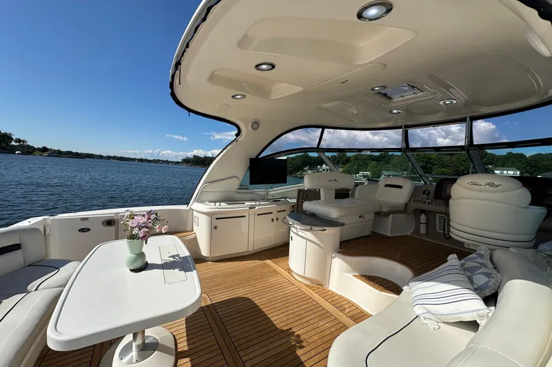 Slide: The Image of Luxurious 2006 Sea Ray 52 Sundancer yacht interior with elegant seating and scenic water view. - 5