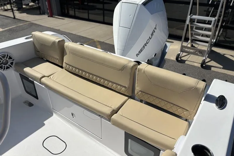 Slide: The Image of 2026 Sportsman Heritage 231 boat with beige seating and Mercury engine. - 11