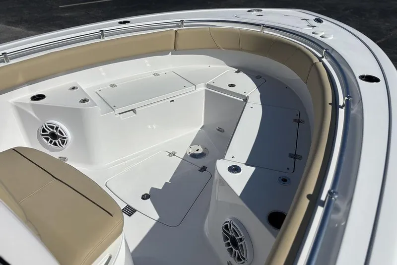 Slide: The Image of 2026 Sportsman Heritage 231 boat interior with tan seating and storage compartments. - 18