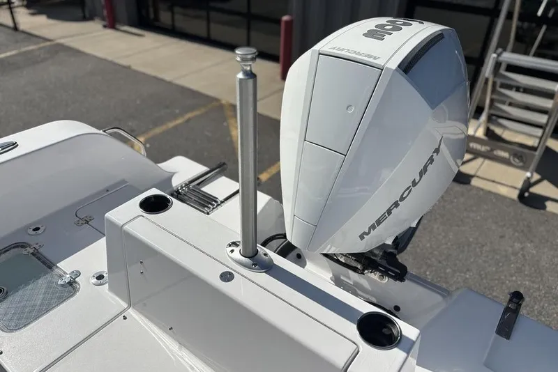 Slide: The Image of 2026 Sportsman Heritage 231 boat with Mercury outboard motor in a parking lot. - 19