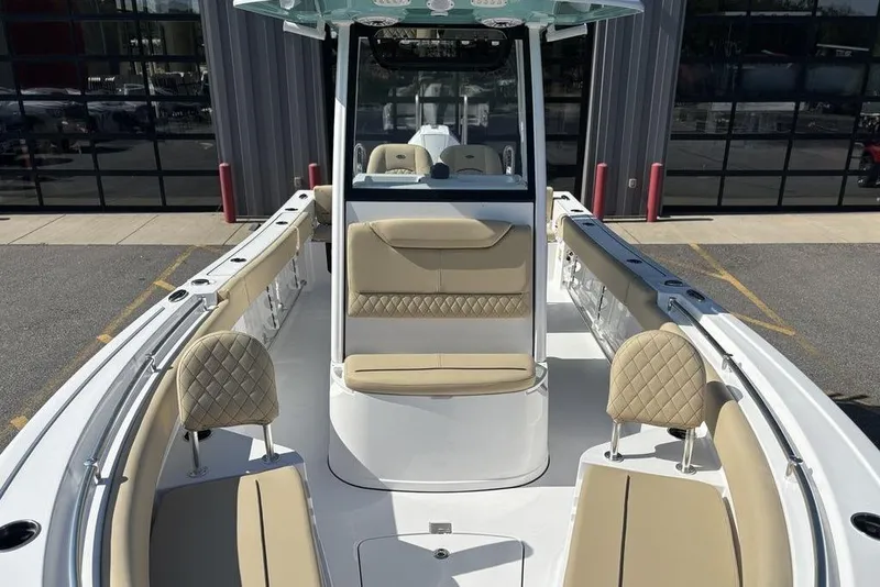 Slide: The Image of 2026 Sportsman Heritage 231 boat interior with beige seating and modern design. - 20
