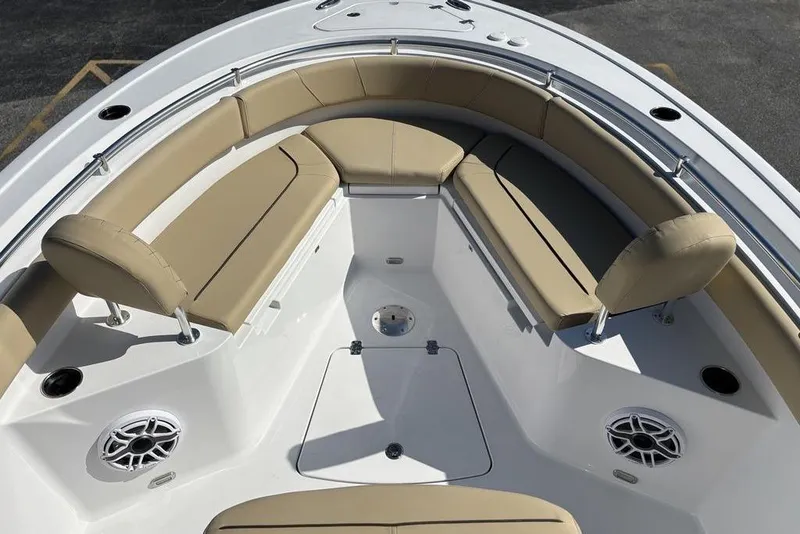 Slide: The Image of 2026 Sportsman Heritage 231 boat interior with beige seating and modern design. - 21