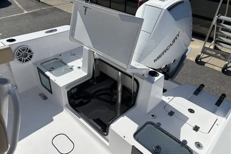 Slide: The Image of 2026 Sportsman Heritage 231 boat deck with Mercury engine and storage compartments. - 23