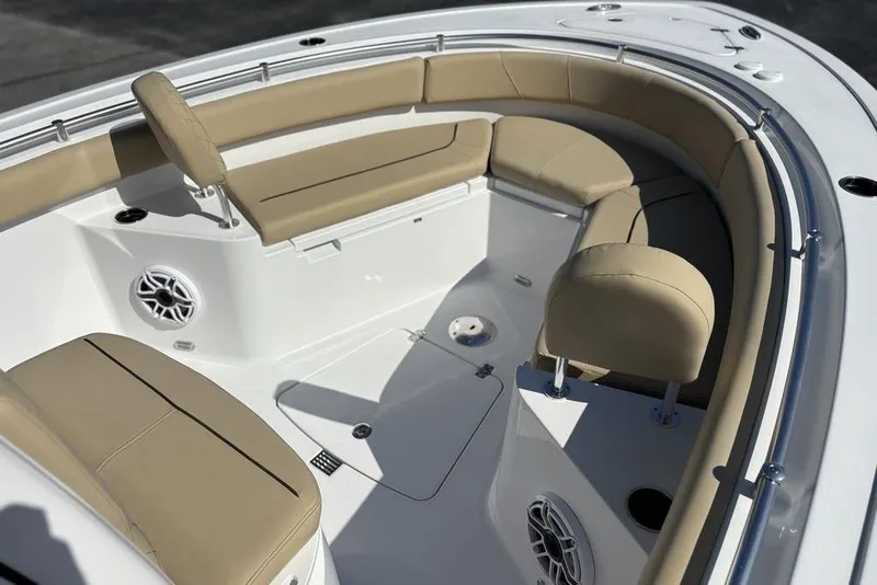 Slide: The Image of 2026 Sportsman Heritage 231 boat interior with beige seating and modern design. - 24