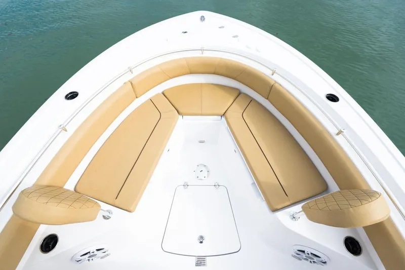 Slide: The Image of 2026 Sportsman Heritage 231 boat with tan seating, viewed from above on water. - 44