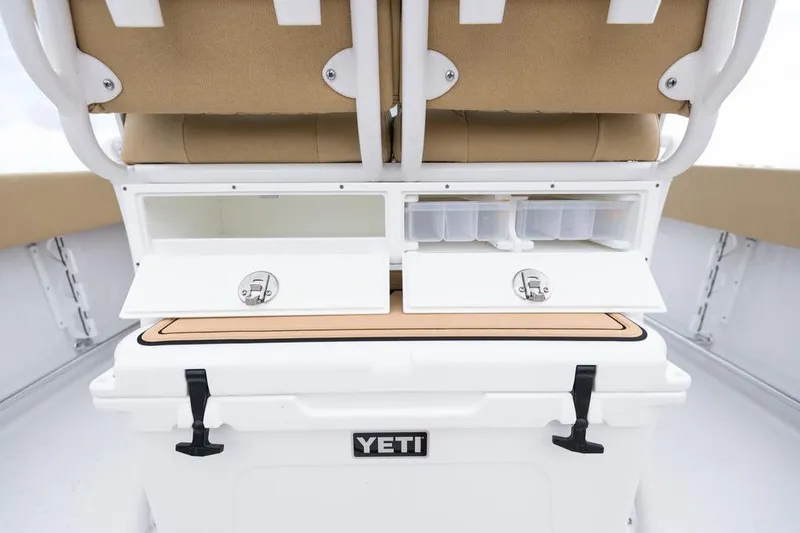 Slide: The Image of 2026 Sportsman Heritage 231 boat interior with storage compartments and Yeti cooler. - 47