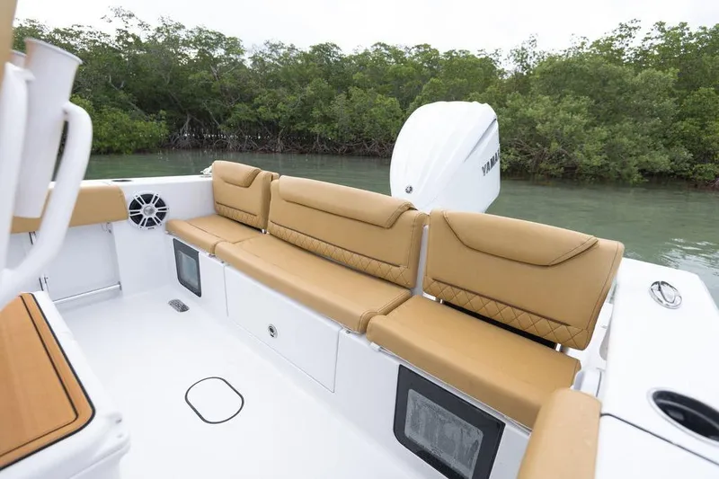 Slide: The Image of 2026 Sportsman Heritage 231 boat interior with tan seating and Yamaha engine, near mangroves. - 48