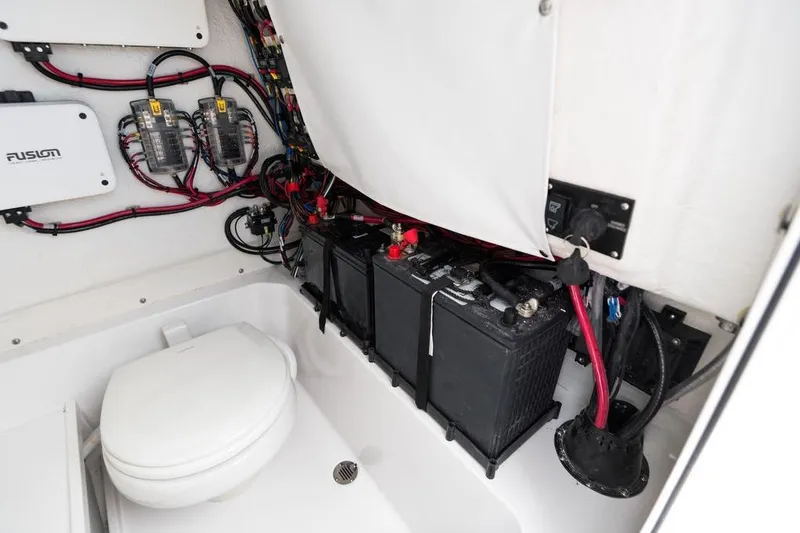 Slide: The Image of Electrical system and toilet in 2026 Sportsman Heritage 231 boat interior. - 49