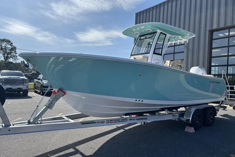 Slide: The Image of 2026 Sportsman Heritage 231 boat on trailer, parked outside a building under a clear sky. - 8