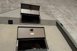 Slide: The Image of 2023 SeaArk 2072 VFX Elite CC boat storage compartments open on deck. - 7