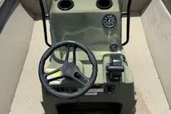 Slide: The Image of 2023 SeaArk 2072 VFX Elite CC boat console with steering wheel and controls. - 8