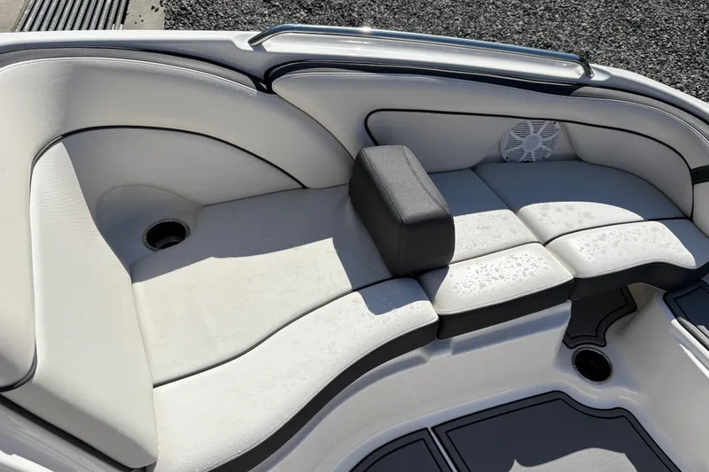 Slide: The Image of 2013 Yamaha Boats AR240 HO interior seating with white cushions and speaker. - 10