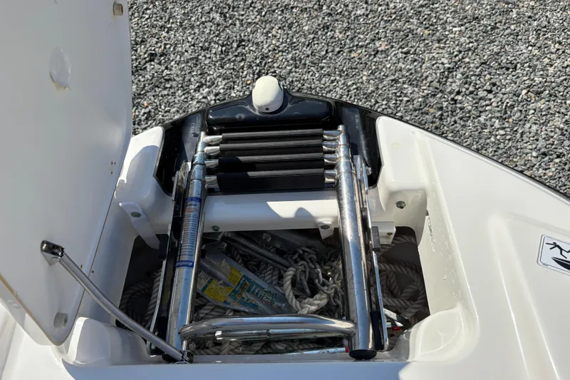 Slide: The Image of 2013 Yamaha AR240 HO boat ladder and storage compartment with ropes. - 12