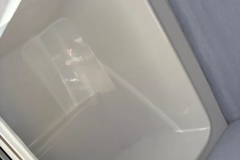 Slide: The Image of Storage compartment of 2013 Yamaha Boats AR240 HO, featuring clean interior design. - 15