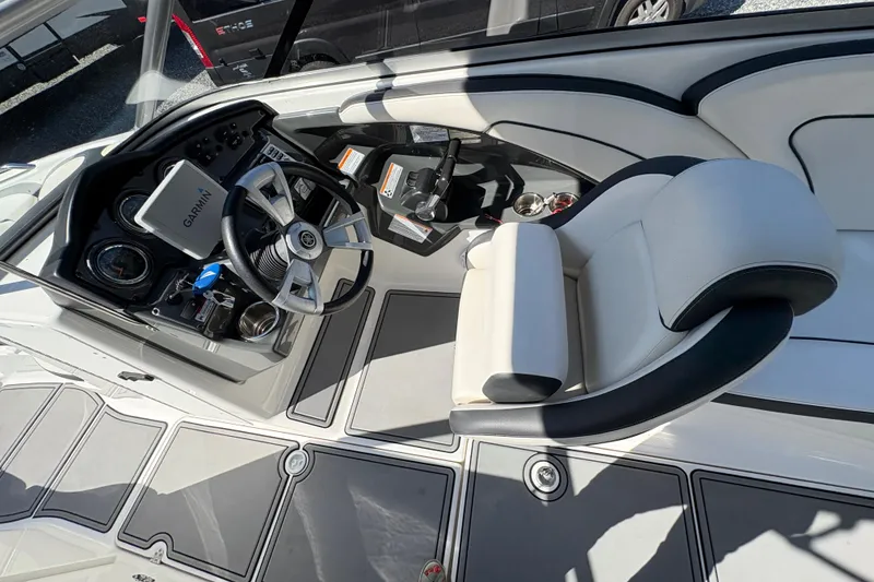 Slide: The Image of 2013 Yamaha Boats AR240 HO cockpit with steering wheel and Garmin navigation system. - 19