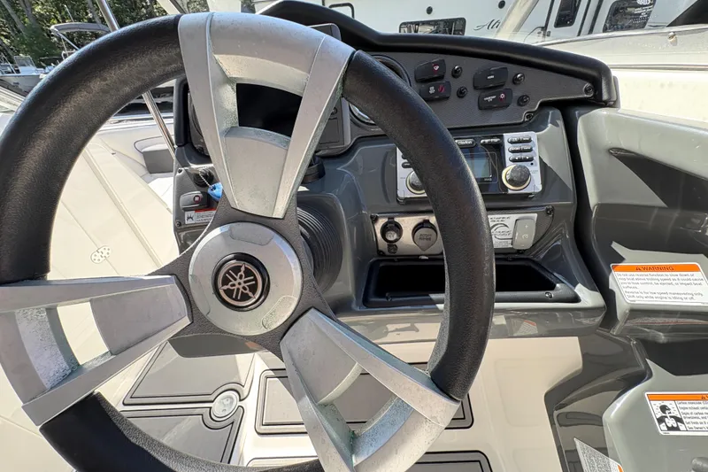 Slide: The Image of 2013 Yamaha Boats AR240 HO steering wheel and dashboard controls. - 21