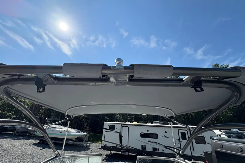 Slide: The Image of 2013 Yamaha Boats AR240 HO with sun canopy under clear blue sky. - 23