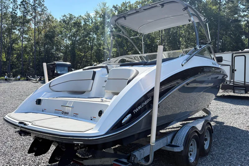 Slide: The Image of 2013 Yamaha Boats AR240 HO on trailer, twin engine, parked outdoors. - 4