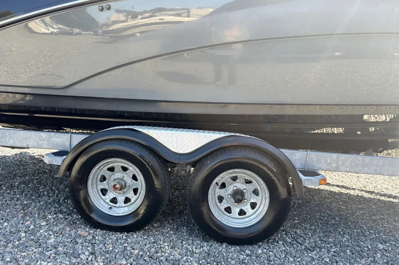 Slide: The Image of Trailer for 2013 Yamaha Boats AR240 HO on gravel surface. - 5