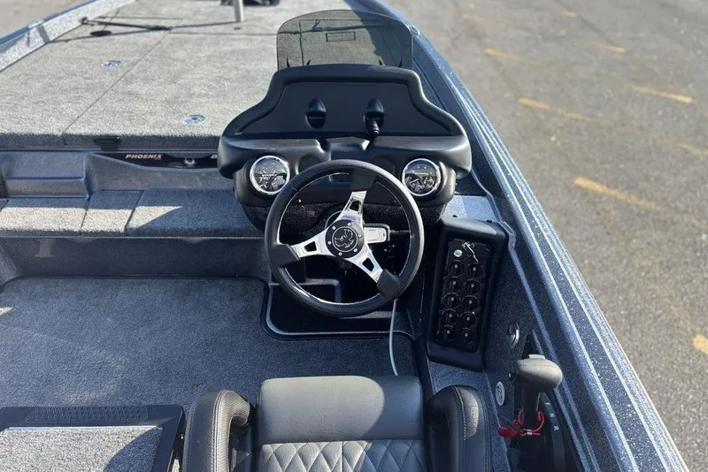 Slide: The Image of 2026 Phoenix 721 ZXL boat cockpit with steering wheel and control panel. - 10