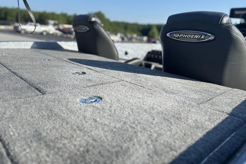 Slide: The Image of 2026 Phoenix 721 ZXL boat interior with gray carpet and branded seats. - 11