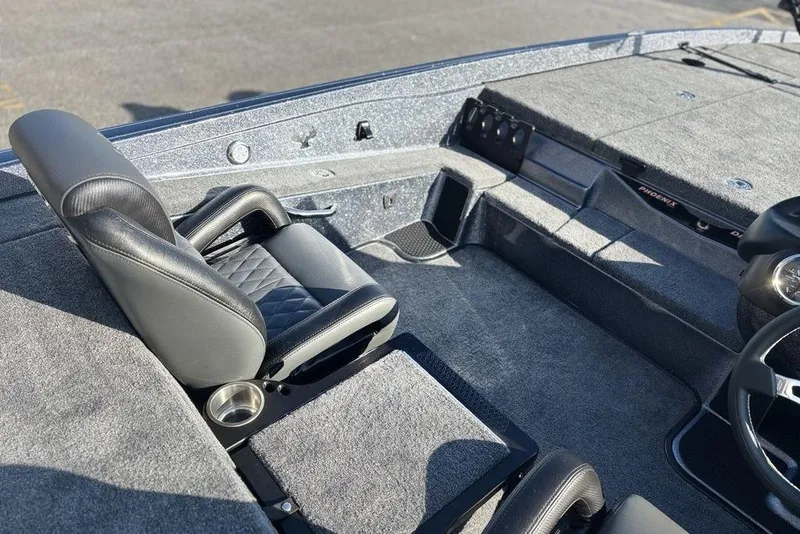 Slide: The Image of Interior of 2026 Phoenix 721 ZXL boat with black leather seating and carpeted flooring. - 15