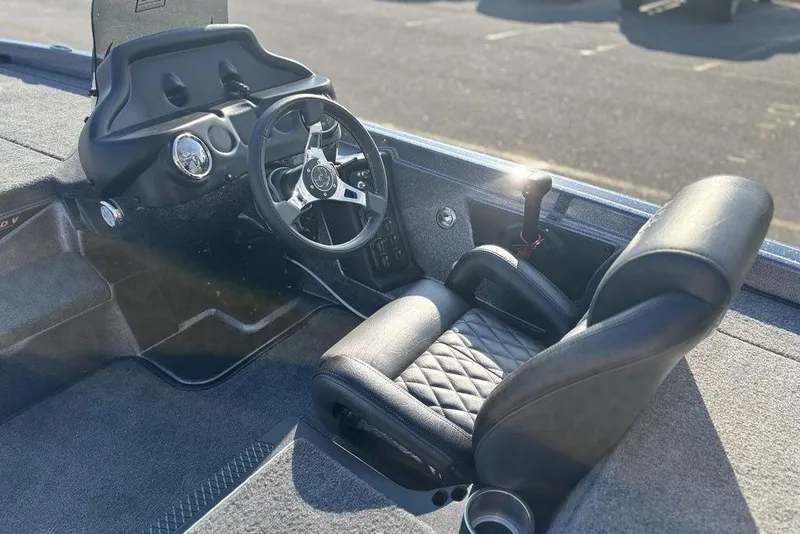 Slide: The Image of 2026 Phoenix 721 ZXL boat interior with steering wheel and cushioned seat. - 16