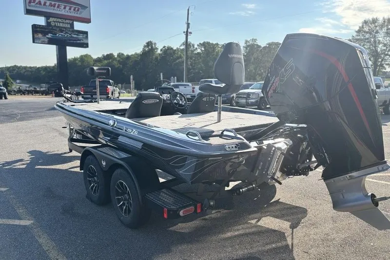 Slide: The Image of 2026 Phoenix 721 ZXL boat with powerful outboard motor in dealership parking lot. - 2