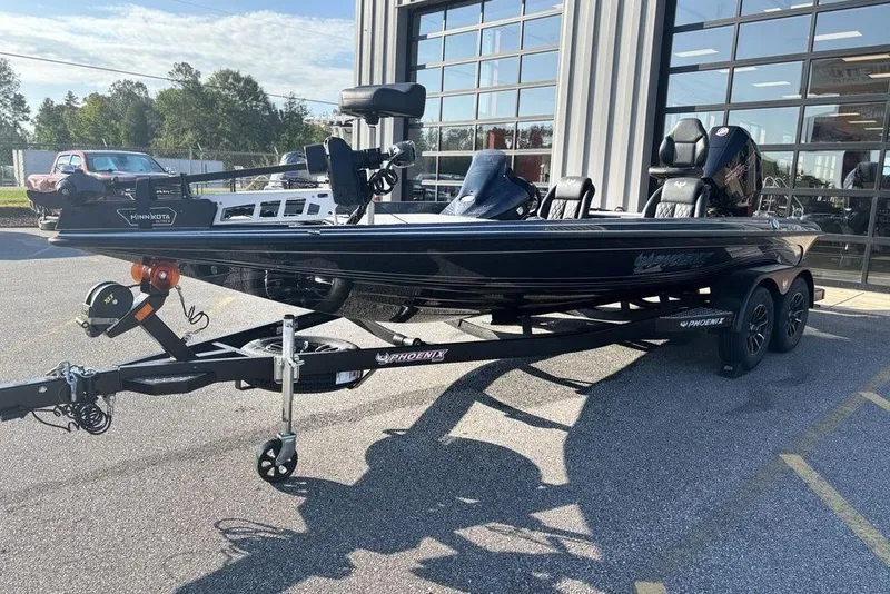 Slide: The Image of 2026 Phoenix 721 ZXL boat on trailer, parked outdoors near a building. - 6