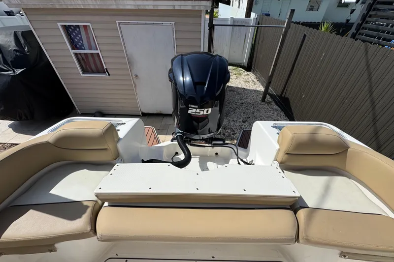 Slide: The Image of 2020 Pioneer 222 Islander boat with Yamaha 250 engine, beige seating, and outdoor storage. - 11