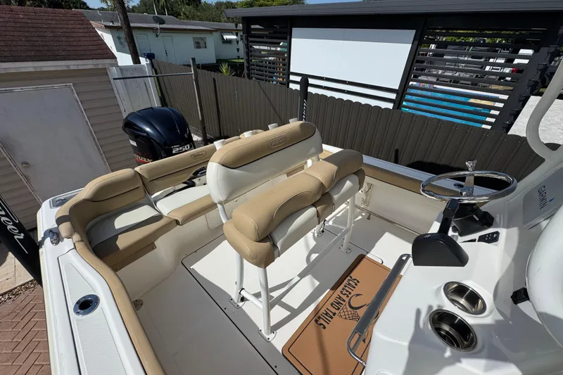Slide: The Image of 2020 Pioneer 222 Islander boat interior with tan seating and Yamaha 250 engine. - 12