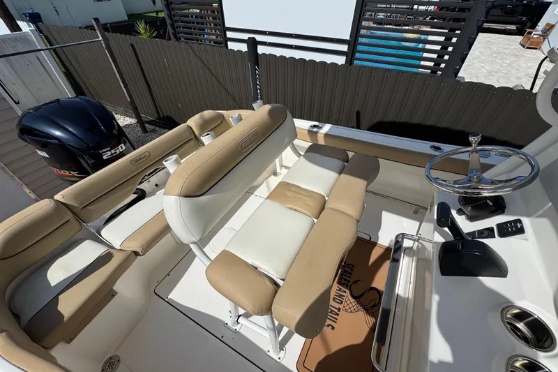 Slide: The Image of 2020 Pioneer 222 Islander boat interior with seating and steering wheel. - 16